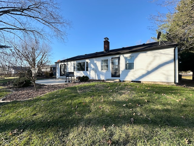 back of property featuring a yard and a patio