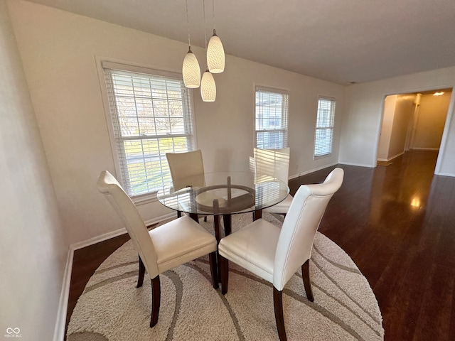 dining space with dark hardwood / wood-style floors and a wealth of natural light