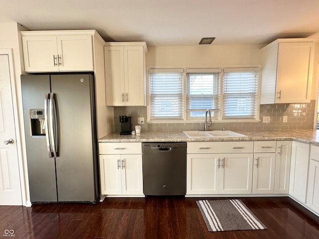 kitchen featuring light stone countertops, dark hardwood / wood-style flooring, stainless steel appliances, sink, and white cabinets