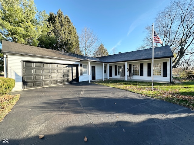 single story home with a porch and a garage