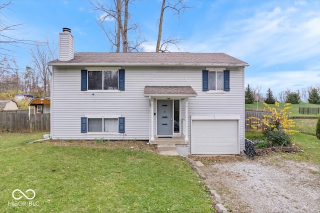 split foyer home featuring a garage and a front lawn