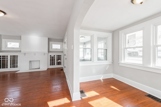 unfurnished living room featuring hardwood / wood-style floors and a fireplace