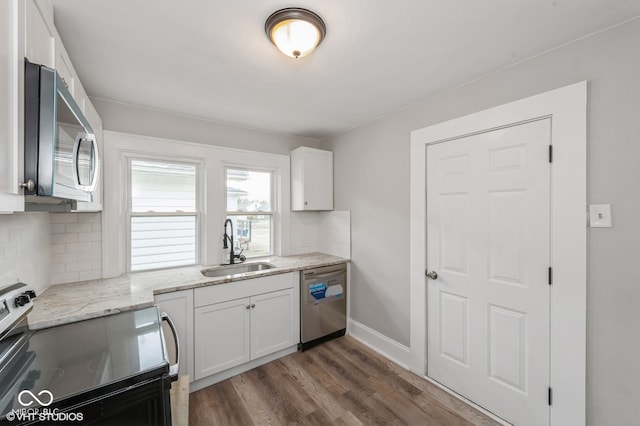 kitchen featuring dark hardwood / wood-style flooring, backsplash, stainless steel appliances, sink, and white cabinets