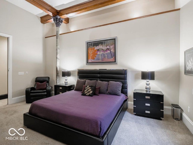 bedroom featuring beam ceiling, light colored carpet, and ceiling fan