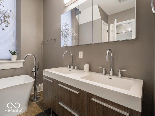 bathroom with a washtub and vanity