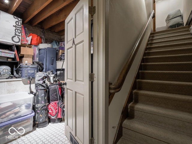 staircase with beam ceiling