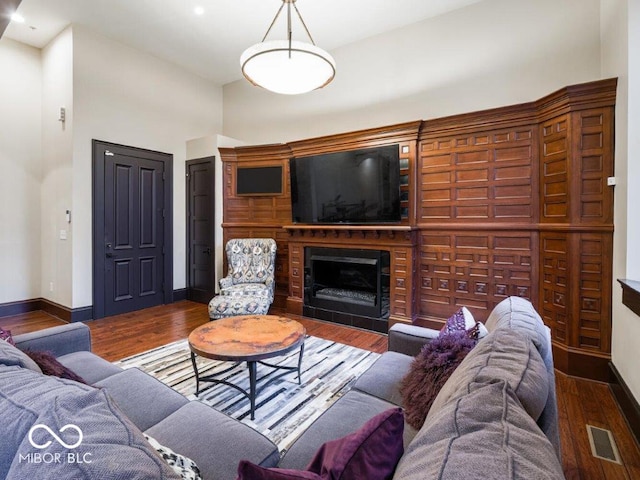 living room with a high ceiling and dark hardwood / wood-style floors