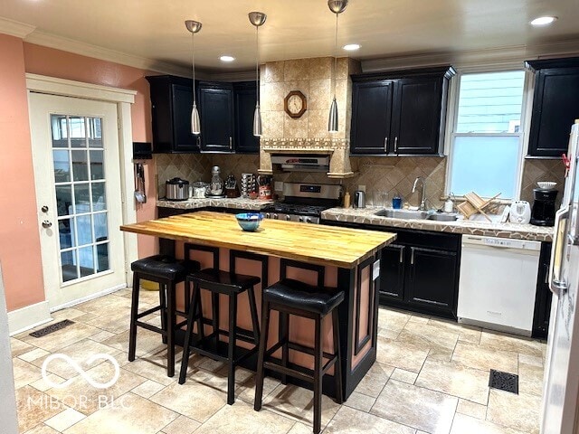 kitchen with sink, wooden counters, stainless steel range oven, white dishwasher, and pendant lighting