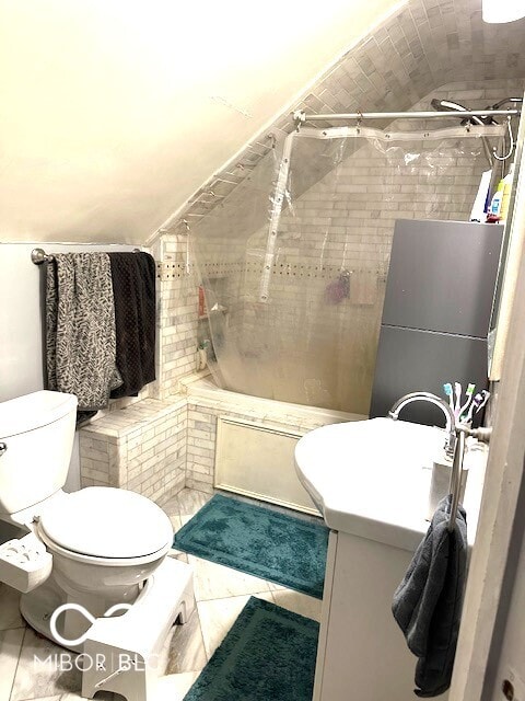 full bathroom featuring tile patterned floors, vanity, toilet, and tiled shower / bath