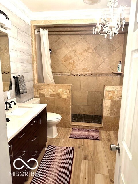 bathroom with vanity, a shower with shower curtain, toilet, tile walls, and wood-type flooring