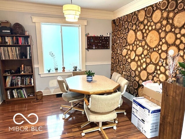 dining area with dark hardwood / wood-style floors and ornamental molding