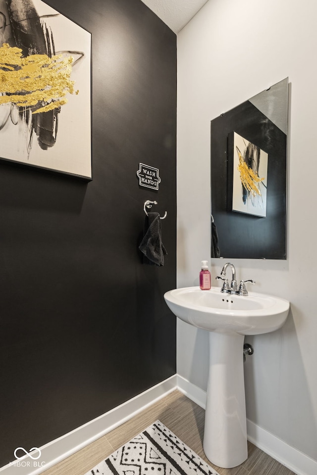 bathroom featuring wood-type flooring and sink