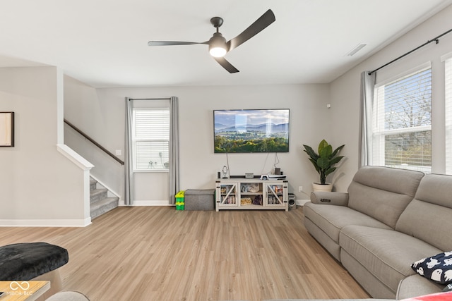 living room featuring light wood-type flooring and ceiling fan