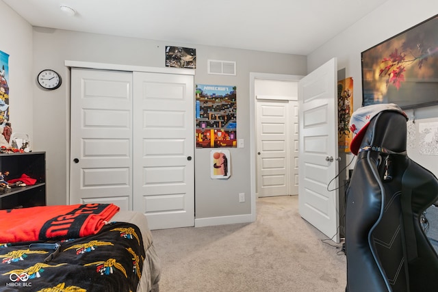 bedroom with light colored carpet and a closet