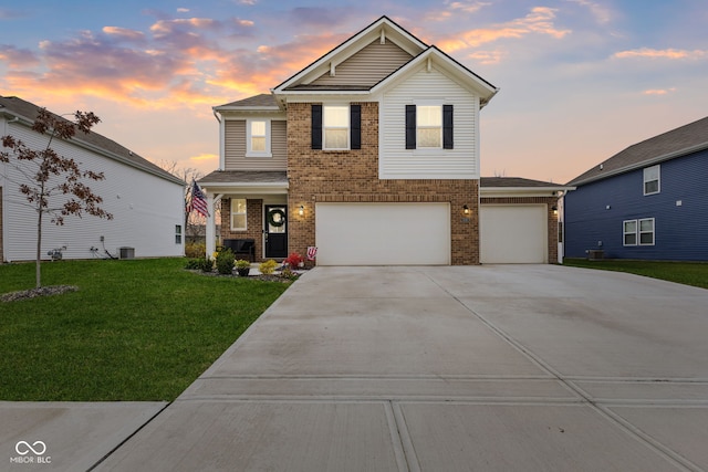 view of front property with a lawn, central AC unit, and a garage