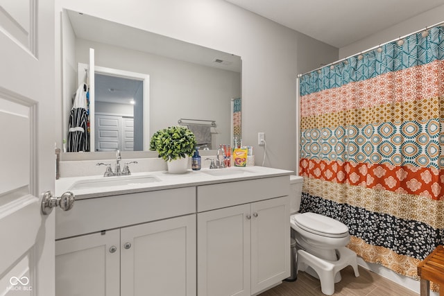 bathroom featuring vanity and toilet