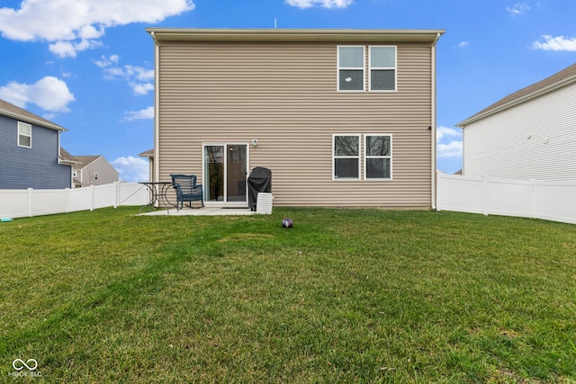 back of property featuring a lawn and a patio