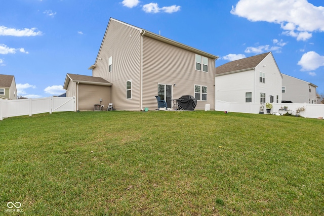 rear view of property with a lawn