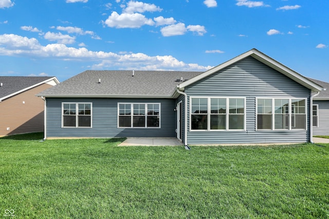 rear view of house with a yard and a patio