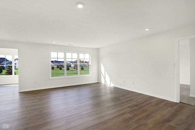 empty room featuring dark hardwood / wood-style flooring