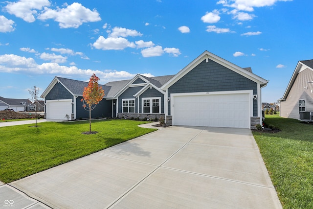 view of front of property featuring a garage and a front lawn