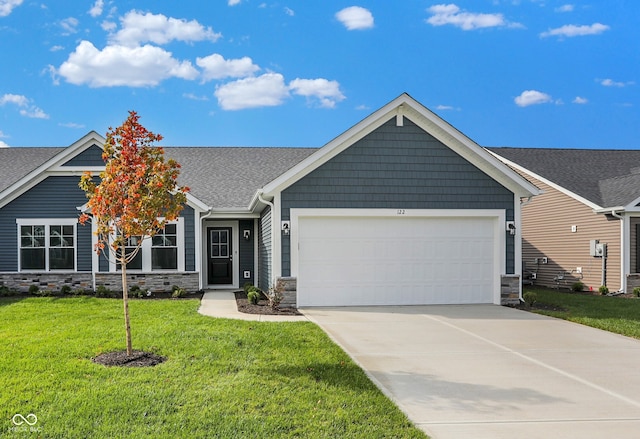 view of front of property featuring a garage and a front lawn