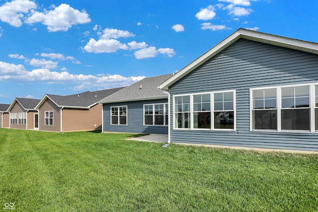 back of property featuring a yard and a patio