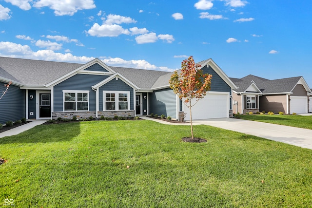 view of front of house with a front yard and a garage