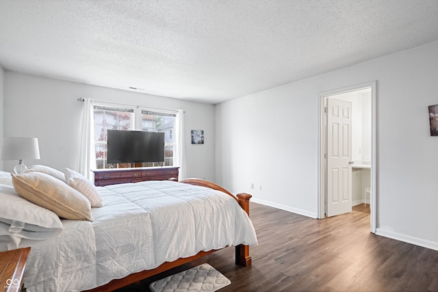 bedroom featuring dark hardwood / wood-style flooring and a textured ceiling