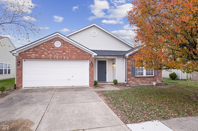 view of front of home with a front lawn and a garage