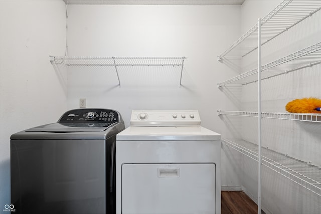 washroom with dark hardwood / wood-style floors and independent washer and dryer