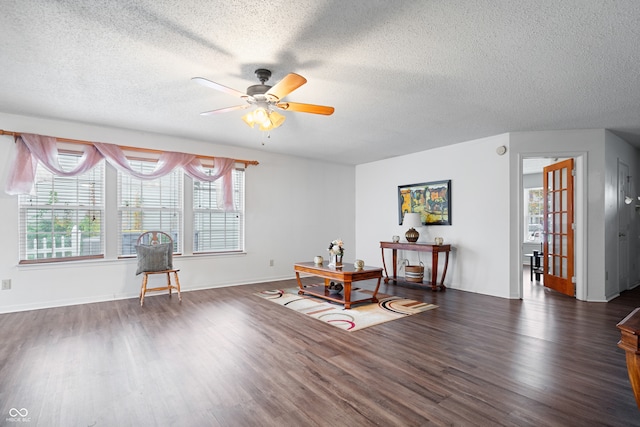 misc room with a textured ceiling, plenty of natural light, ceiling fan, and dark wood-type flooring