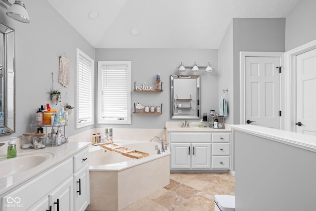 bathroom with vanity and a bath