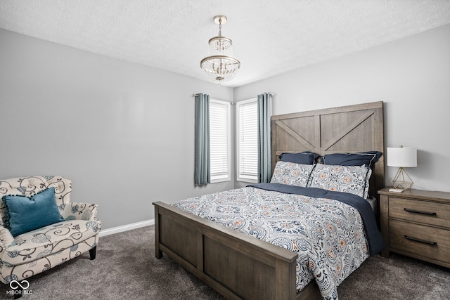 carpeted bedroom featuring a chandelier and a textured ceiling