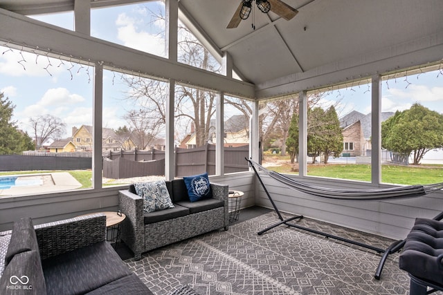 sunroom / solarium featuring a wealth of natural light, ceiling fan, and lofted ceiling