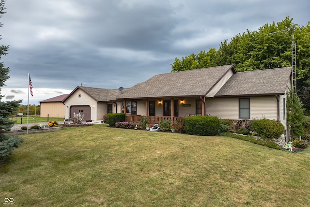 ranch-style house featuring a porch, a garage, and a front yard