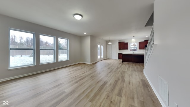 unfurnished living room with light hardwood / wood-style floors