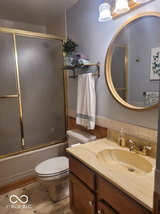 full bathroom with shower / bath combination with glass door, vanity, and toilet