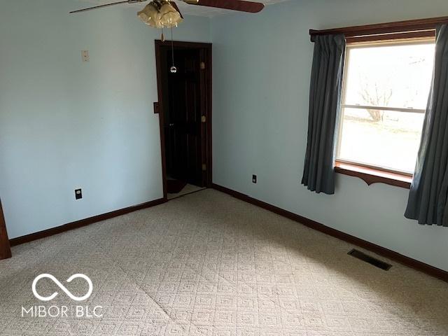 carpeted empty room with ceiling fan