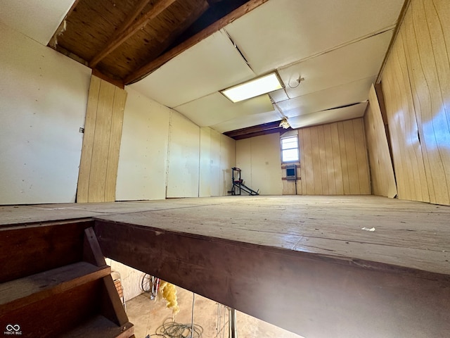 interior space with wooden walls and lofted ceiling