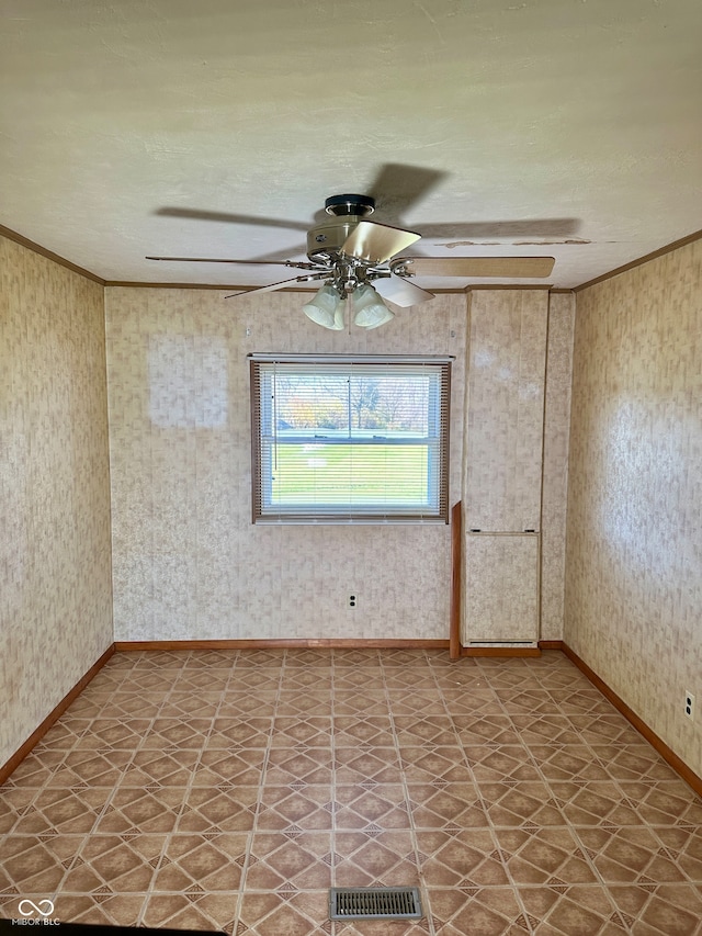 unfurnished room featuring a textured ceiling, ceiling fan, and ornamental molding