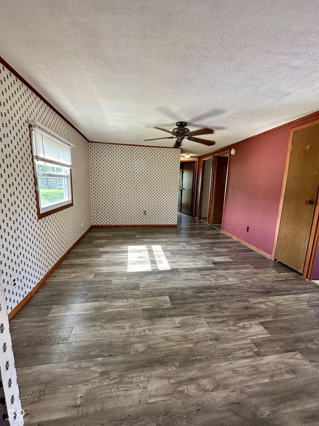 8418 S State Road 39, Clayton, IN 46118 - unfurnished room featuring a textured ceiling, ceiling fan, wood finished floors, wallpapered walls, and baseboards