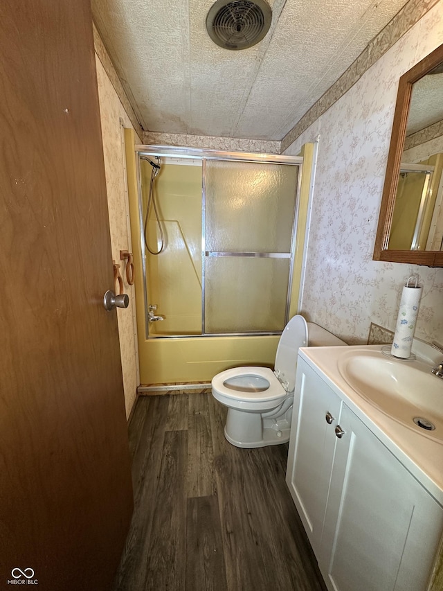 8418 S State Road 39, Clayton, IN 46118 - full bathroom with wallpapered walls, wood finished floors, vanity, combined bath / shower with glass door, and toilet