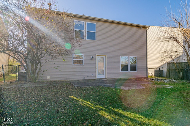 rear view of property featuring a lawn and a patio