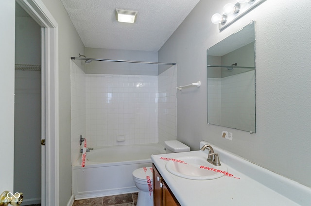 full bathroom featuring tile patterned flooring, a textured ceiling, toilet, vanity, and tiled shower / bath