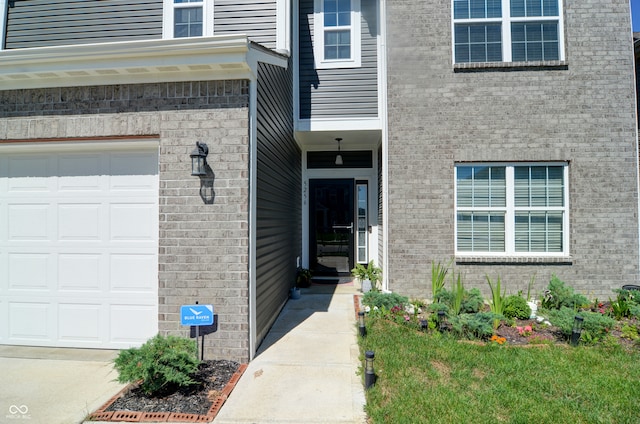 view of exterior entry with a garage