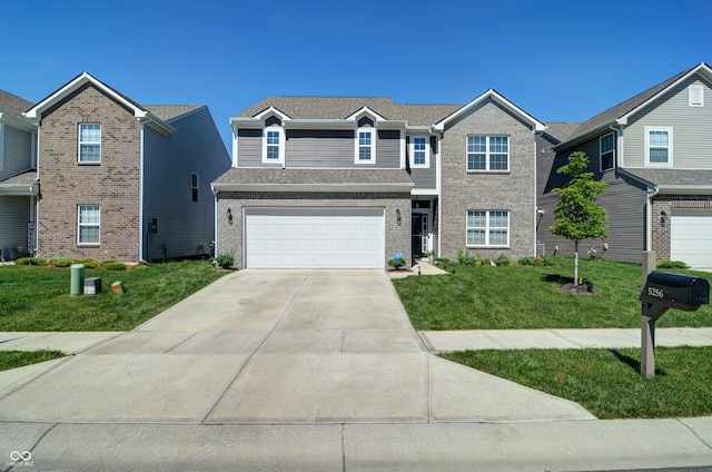 view of front of home with a front yard and a garage