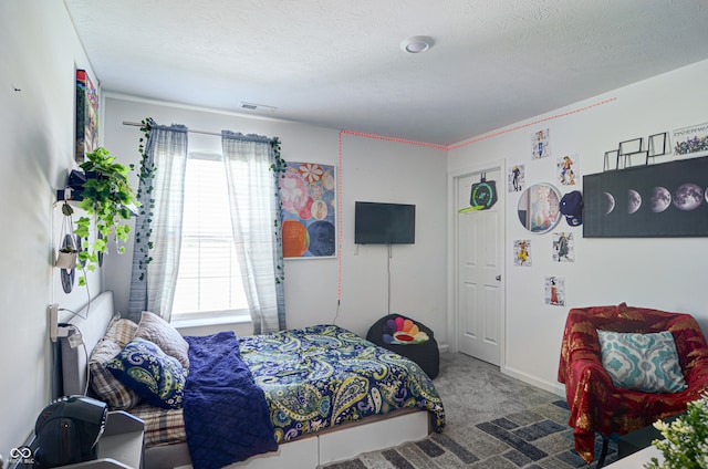 carpeted bedroom featuring multiple windows, a textured ceiling, and ornamental molding