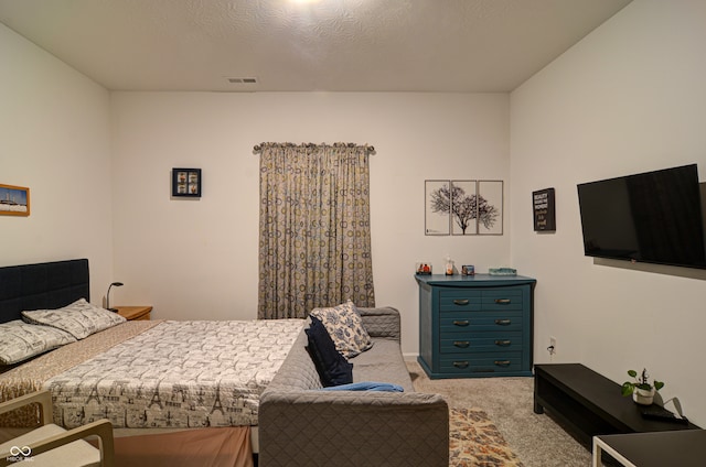 carpeted bedroom featuring a textured ceiling