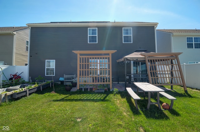 rear view of property with a yard